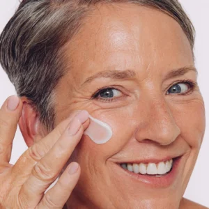 Woman applying CellDerma face cream
