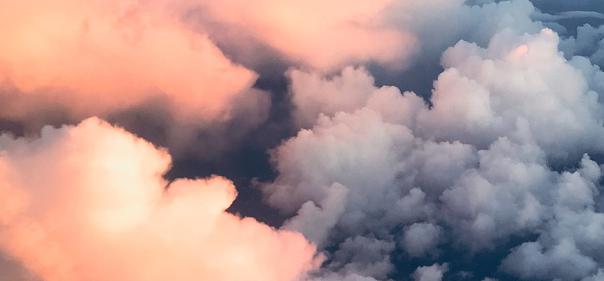 A photo of pink and blue fluffy clouds from above