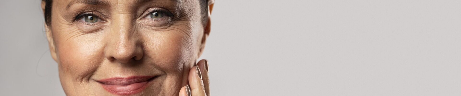 CellDerma Mature Woman Holding Face Smiling Content Image