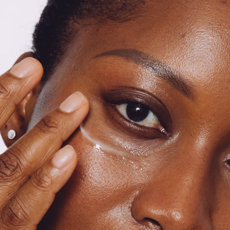 Close-up of under-eye skincare application showing CellDerma Eyelift Corrective Serum texture on skin.
