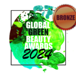 Global Green Beauty Awards 2024 bronze award badge recognising achievement in sustainable beauty innovation.